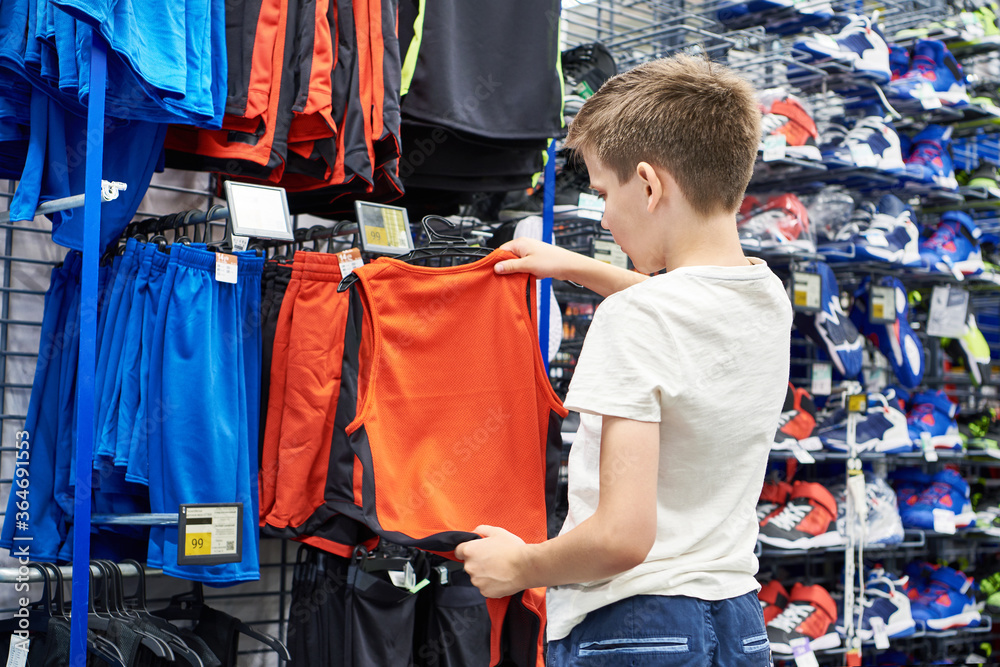 Boy with red t-shirt in basketball sport shop Boy with red t-shirt in basketball sport shop