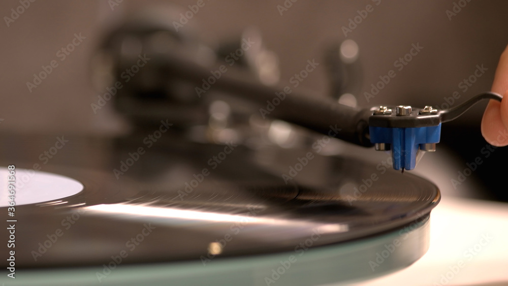 Obraz premium Retro music is playing by the turntable. Close-up photo of the record-player.