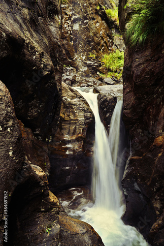 Small waterfall from between rocks in Austria