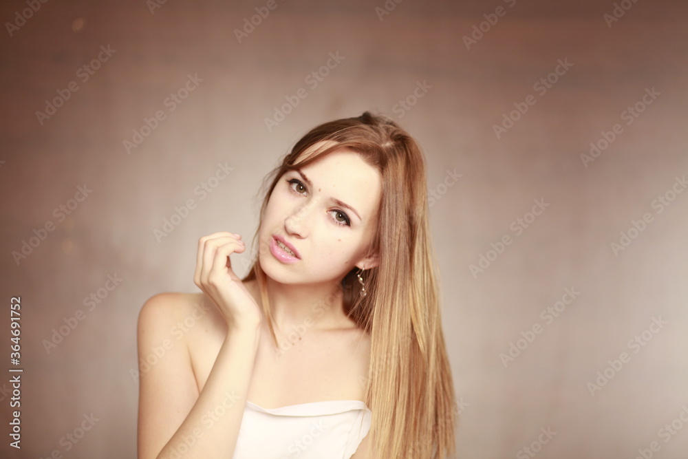 Emotional girl portrait on the brown background