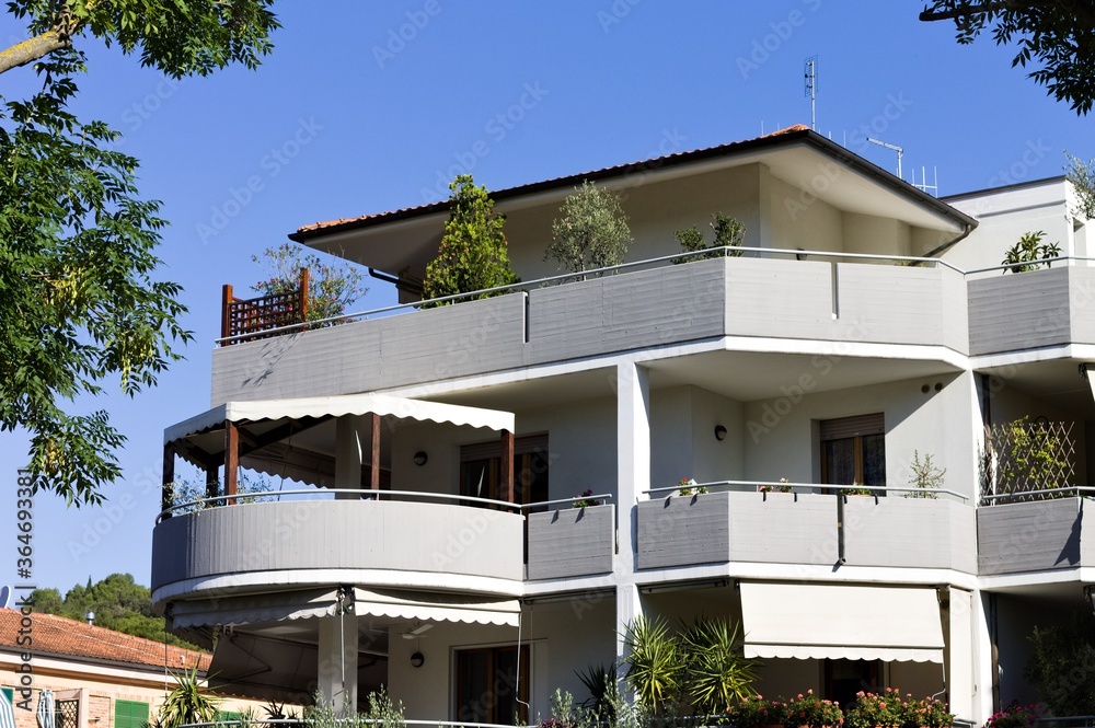 Obraz premium A house with large balconies and ornamental plants (Pesaro, Italy, Europe)