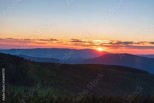 Sunset with colorful sky from Dlouhe strane hill in Jeseniky mountains in Czech republic