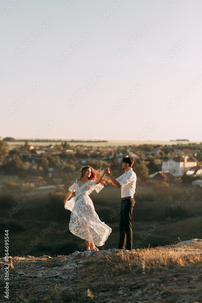 Beautiful wedding couple in nature in boho style. Wedding in the European style of fineart at sunset.