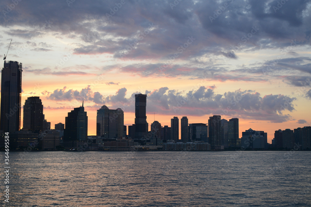 New York, USA - May 30, 2019: Beautiful view to Brooklyn side from Battery Park in Lower Manhattan during sunset