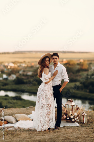 Beautiful wedding couple in nature in boho style. Wedding in the European style of fineart at sunset.