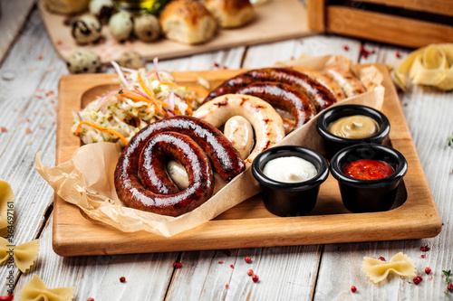 Grilled sausages with sauerkraut and sauces
