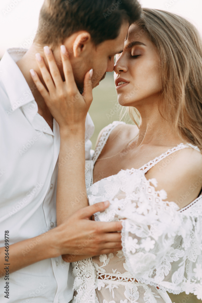 Beautiful couple in nature in boho style. Wedding in European style fine art at sunset. Beautiful couple in nature in boho style. Wedding in European style fine art at sunset.