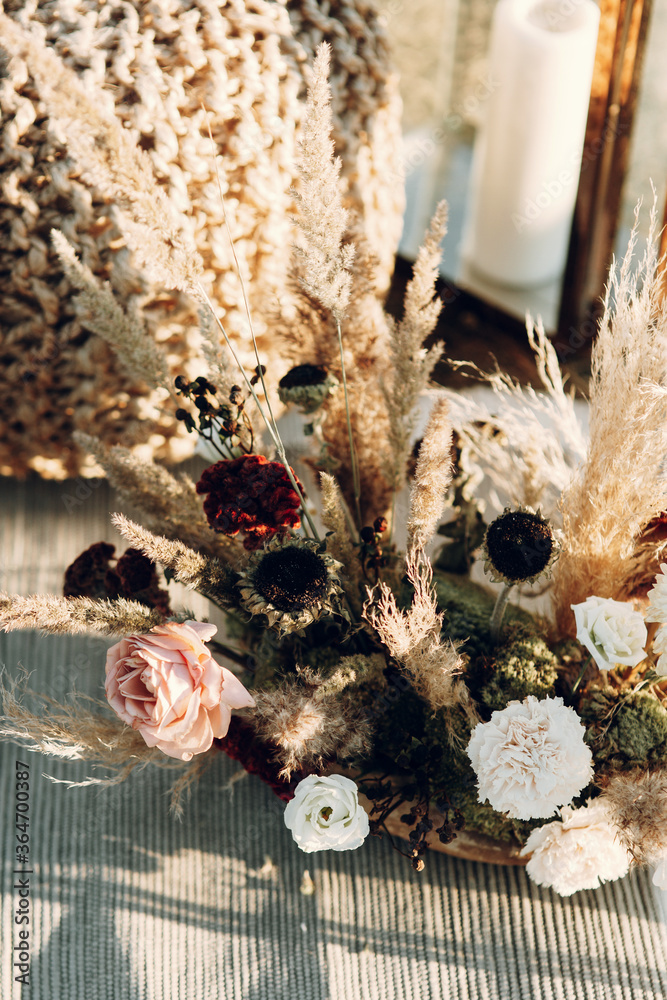 Wedding decor from dried flowers in boho style. Wedding in European style fine art at sunset. - obrazy, fototapety, plakaty 
