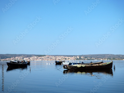 Sardinia view of Sant Antioco from the lagoon  in the foreground boats typical for fishing in the lagoon  above