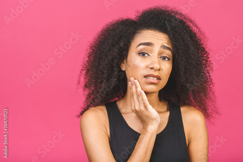 Beautiful young african american woman over isolated background touching mouth with hand with painful expression because of toothache or dental illness on teeth. Dentist concept. © denis_vermenko