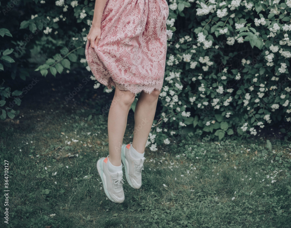 jump: girl in sneakers and a pink lace dress jump: girl in sneakers and a pink lace dress