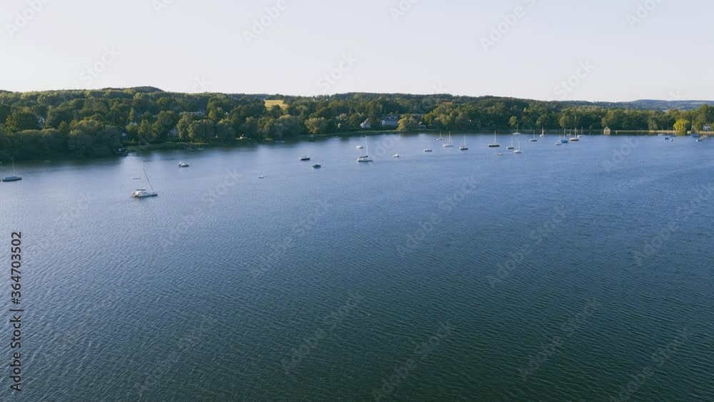 Drone flies over boats at Ammersee. Breathtakingly beautiful recreation area near Munich. Panoramic view of the lake with the boats Drone flies over boats at Ammersee. Breathtakingly beautiful recreation area near Munich. Panoramic view of the lake with the boats