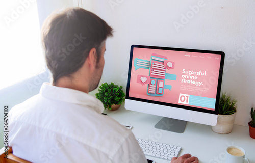 man browsing digital business website on computer