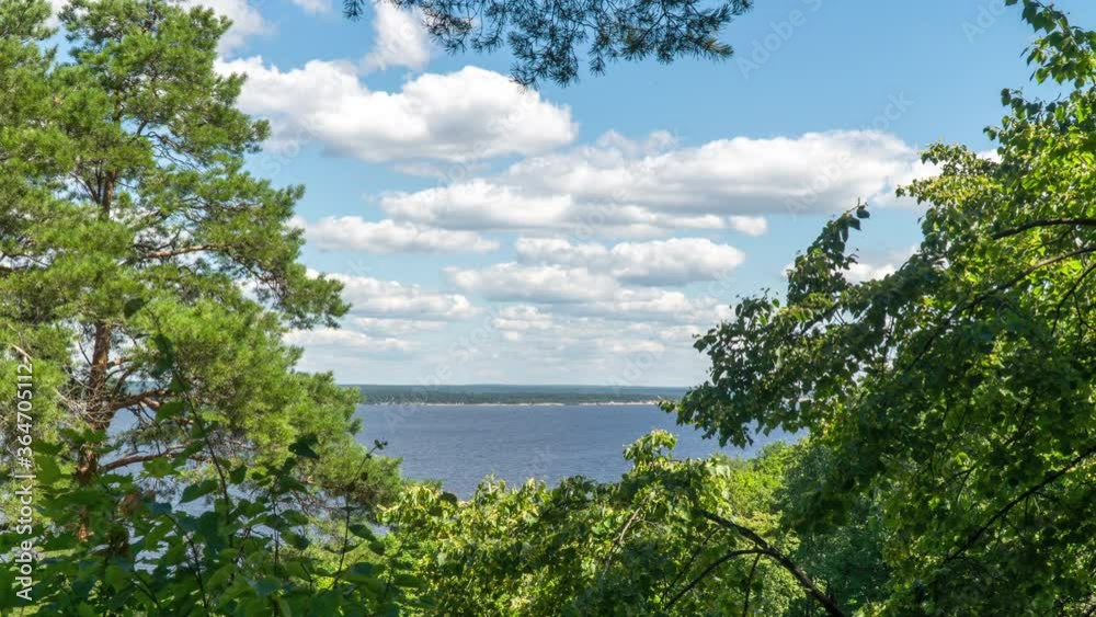 Moving clouds over the river surrounded by trees on a summer morning. Timelapse Moving clouds over the river surrounded by trees on a summer morning. Timelapse