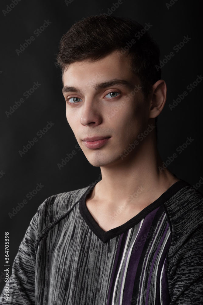 Portrait of serious young man on black background Portrait of serious young man on black background