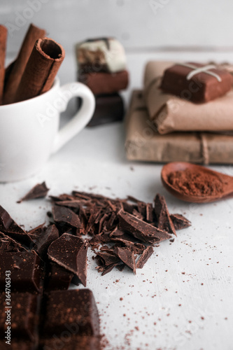 Chocolates with cinnamon and cocoa. On a gray background.