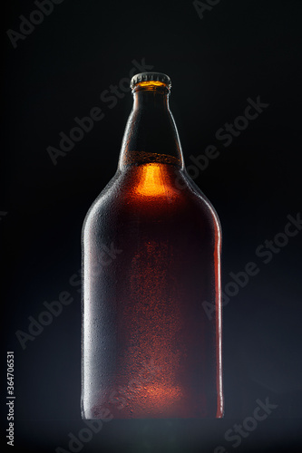 Beer bottle on dark background, copy space © fotofabrika