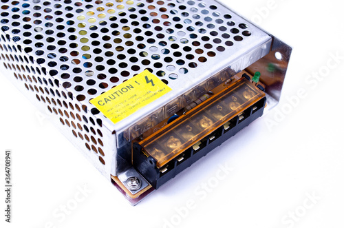 Power supply for LED strip on a white and black background in macro. 240v to 12v converter
