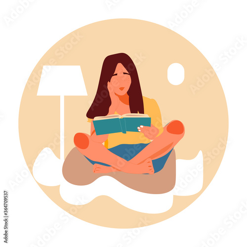 Young girl or woman sitting on pillows at home, reading a book in .
