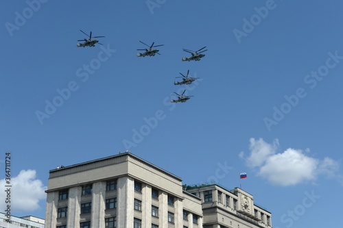 A group of Ka-52 alligator reconnaissance and attack helicopters (Hokum B) in the sky over Moscow during a parade dedicated to the 75th anniversary of the Victory