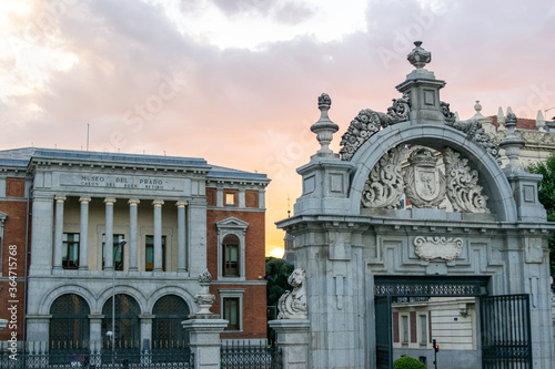 Madrid, Spain / July 13 2020 / Photo of an attractive guy next to Alcala gate in Madrid during sunset	