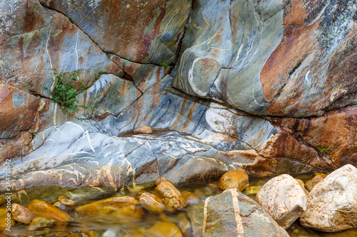 Color and shapes of the rock eroded by the passage of water. Truchillas River, Sierra de la Cabrera, León, Spain. photo