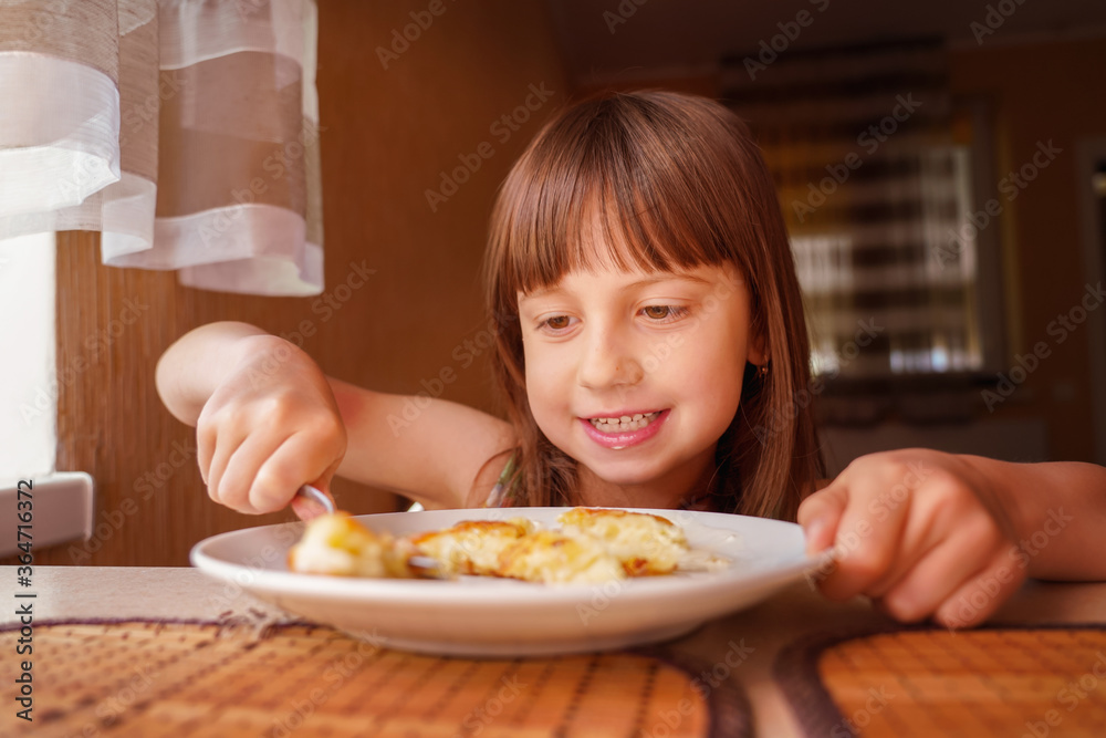 Beautiful girl eating cheesecakes for breakfast. Horizontal image. Beautiful girl eating cheesecakes for breakfast. Horizontal image.