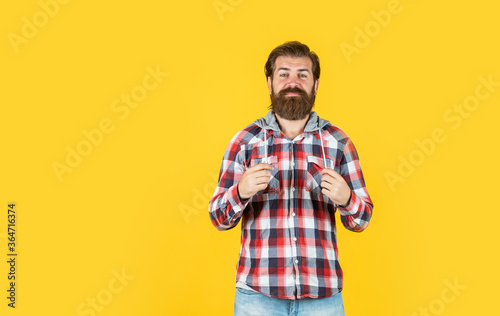 Confident and handsome brutal man. copy space. portrait of handsome bearded man in plaid shirt. man wearing casual clothes. brutal happy man with beard standing indoor. Young and brutal © be free