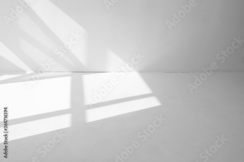 light spots from the window on the white floor and wall