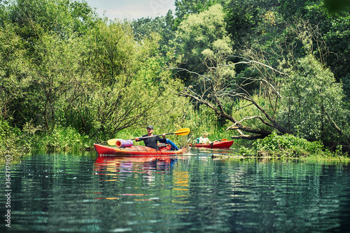 Happy best friends having fun on a kayaks. Kayaking on the river.