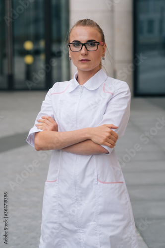 A young beautiful female doctor holds a stethoscope . The concept of a European doctor, copy space. ©  drugoenebo