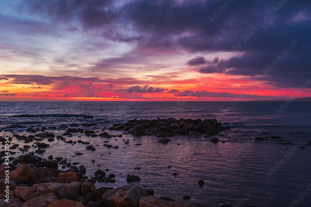 Scenic colorful sunset at the sea coast. Good for wallpaper or background image Radiant sea beach sunset Panoramic photo .Sunset sea horizon sky clouds. Sea sand beach
