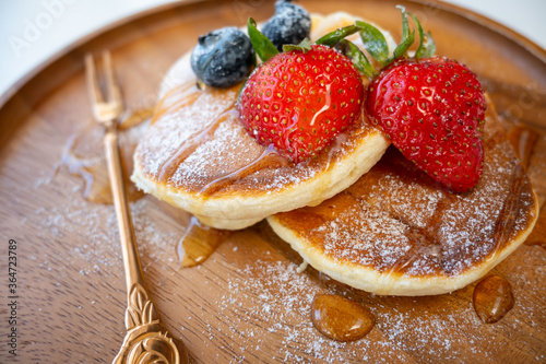 Honey pancake with strawberry and blueberry on top