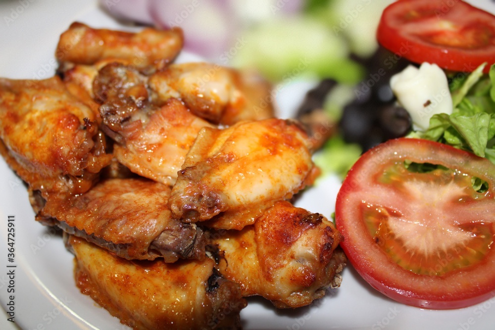 roasted chicken with salad on food table roasted chicken with salad on food table