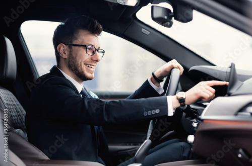 Man In Glasses Sitting In New Auto Checking Dashboard © Prostock-studio