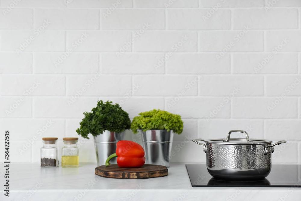 Kitchen counter with products and saucepot on stove Kitchen counter with products and saucepot on stove