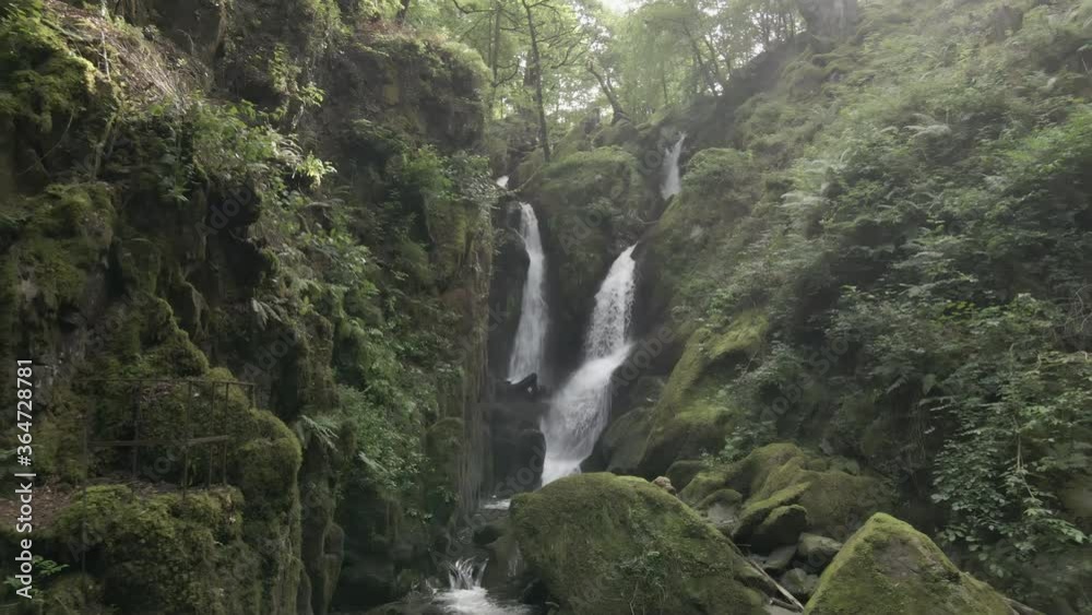 4K UHD drone footage of Stock Ghyll Force waterfall at Ambleside in the Lake District, Cumbria, England, UK