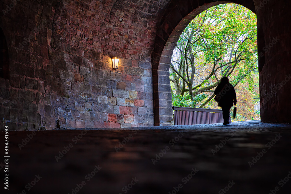 Silhouette of Woman in the Pedestrian Tunnel