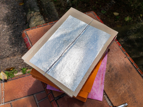 Photography Stack of silver Chinese joss paper which is used for ancestral worship or prayer