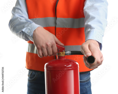 Worker using fire extinguisher on white background, closeup photo