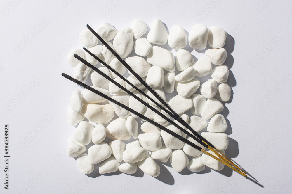 top view of aroma sticks on square made of stones on white background, panoramic shot top view of aroma sticks on square made of stones on white background, panoramic shot