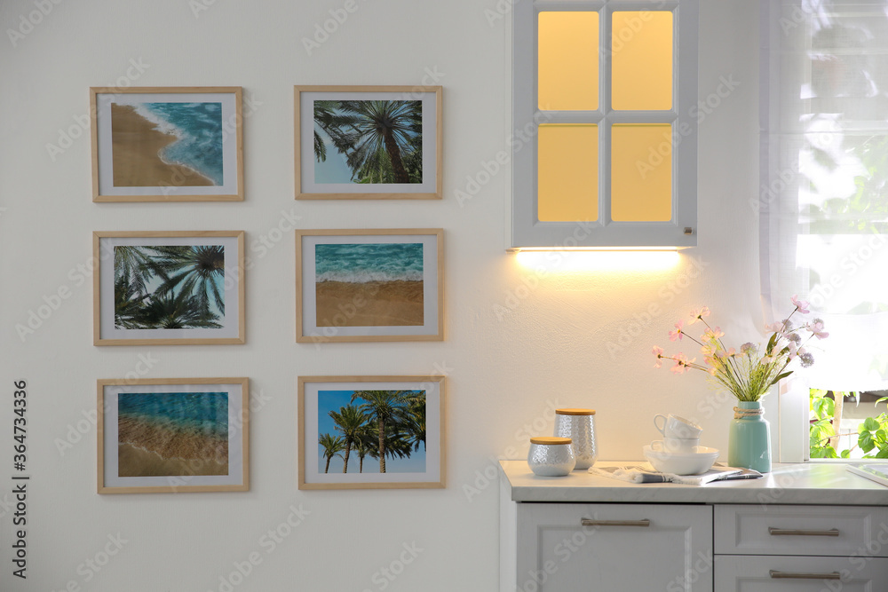 Fototapeta premium Stylish kitchen interior with beautiful artworks on wall