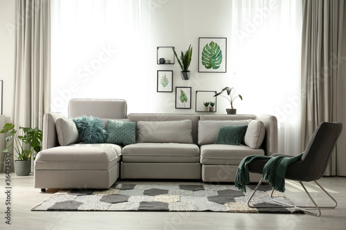 Comfortable large sofa in light room. Interior design