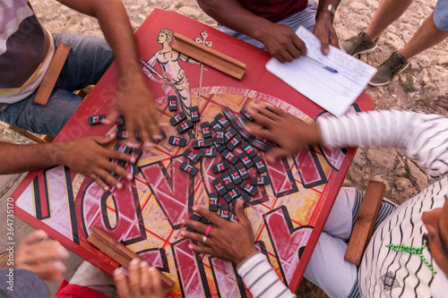 Photography Peoples hand on a table playing domino in the street of Trinidad, Cuba