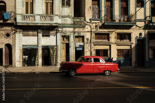 Amazing old american car on streets of Havana with colourful buildings in background. Havana  Cuba.
