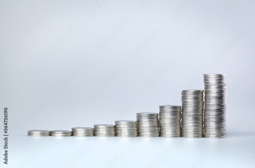 Stack of silver coin like income graph. coins arranged as a graph. Stack of silver coin like income graph. coins arranged as a graph.