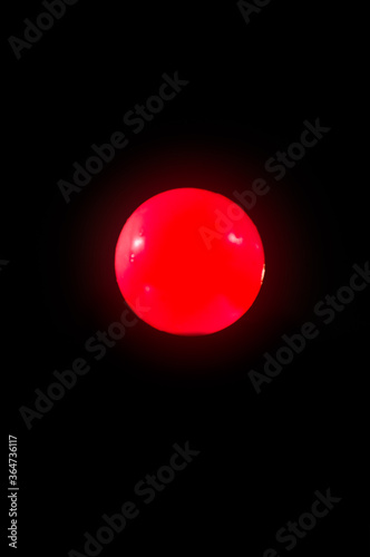red ball on black background