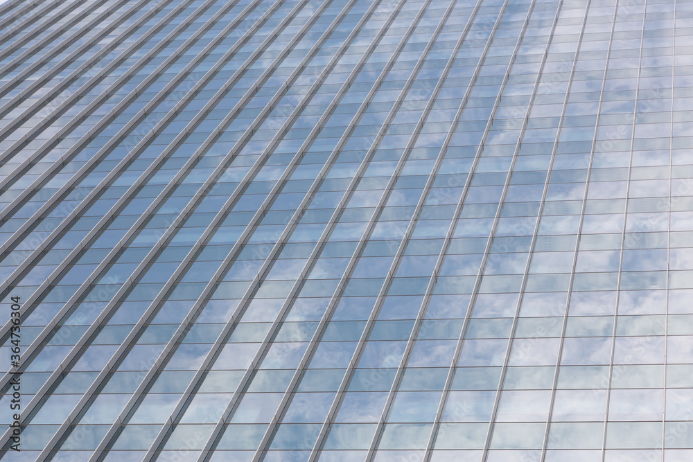 Abstract architecture of a modern building. Clouds reflected in windows of modern office building Abstract architecture of a modern building. Clouds reflected in windows of modern office building