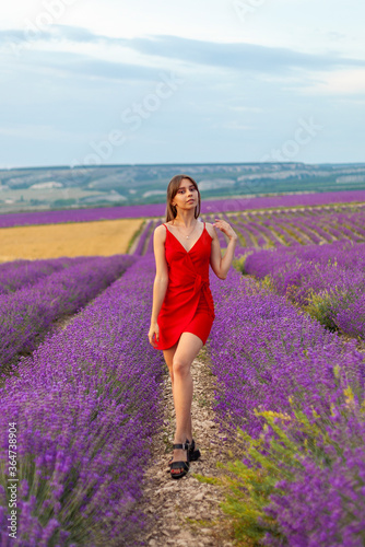 Fototapeta Naklejka Na Ścianę i Meble -  young woman running in lavender field