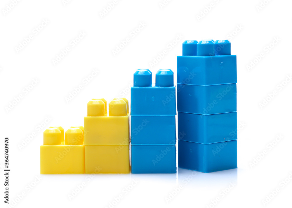 Naklejka premium Colorful stacked toy plastic building blocks isolated on white background